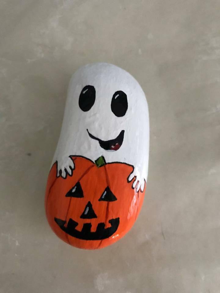 Ghost on a pumpkin rock painting