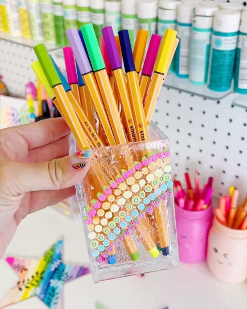 DIY Pen and Pencil storage with a fruit pattern on the side holding colored pencils