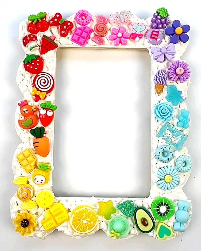 DIY Picture frame craft covered in clay frosting and embellishments
