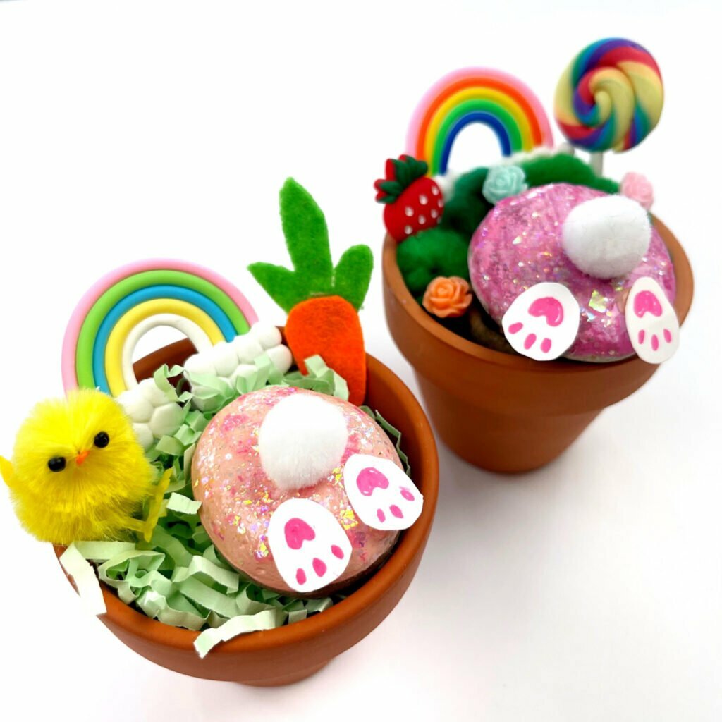 Bunny Craft example - there are two finished products showing upside bunnies stuck in flower pots with decorations around them