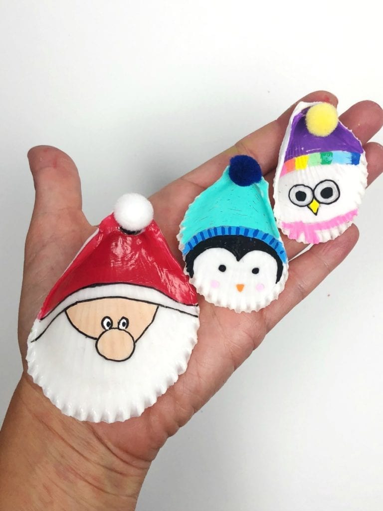 Ornaments that have been painted to look like Santa, a penguin, and an owl