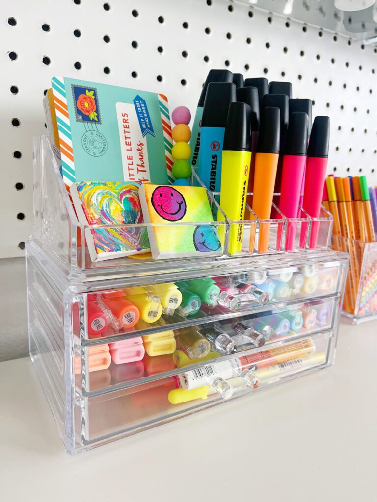 Clear makeup bins being used to organize art supplies 