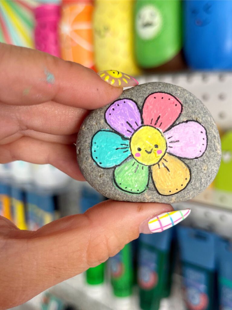 Colorful spring flower painted on a rock