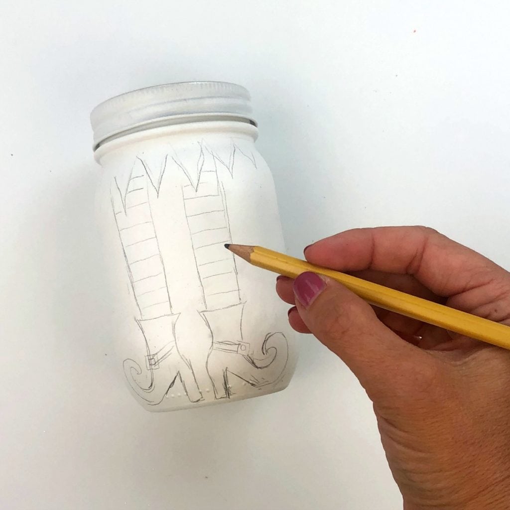 Sketching the leg design onto the jar