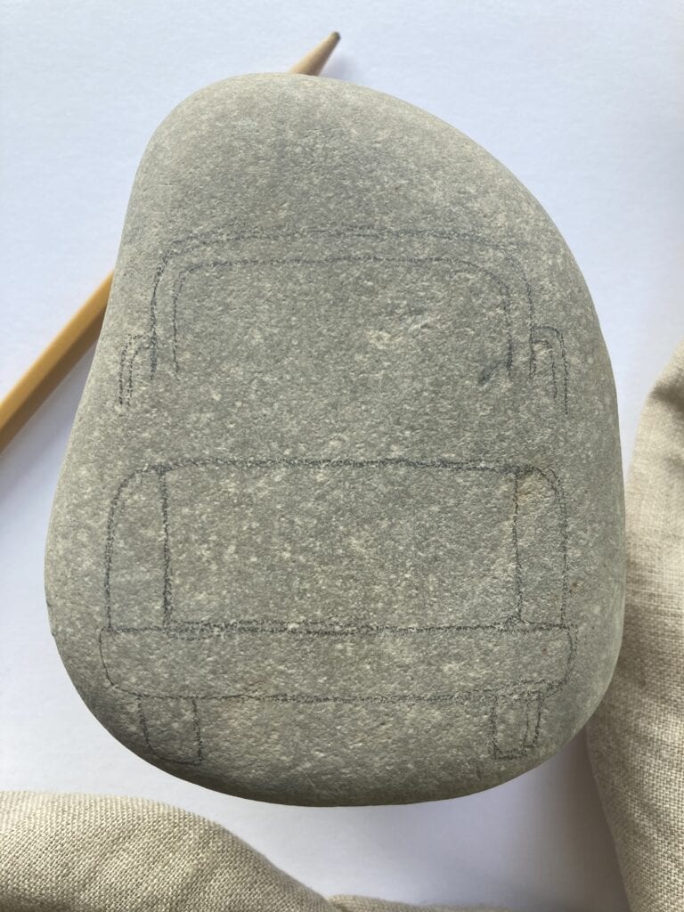 Truck design is sketched onto the rock with space left for the contents of the truck bed. The window is disconnected from the base with a bit of a space. 