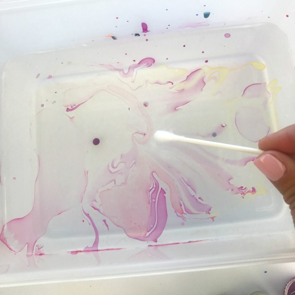 Cleaning up the nail polish after marbling a pumpkin