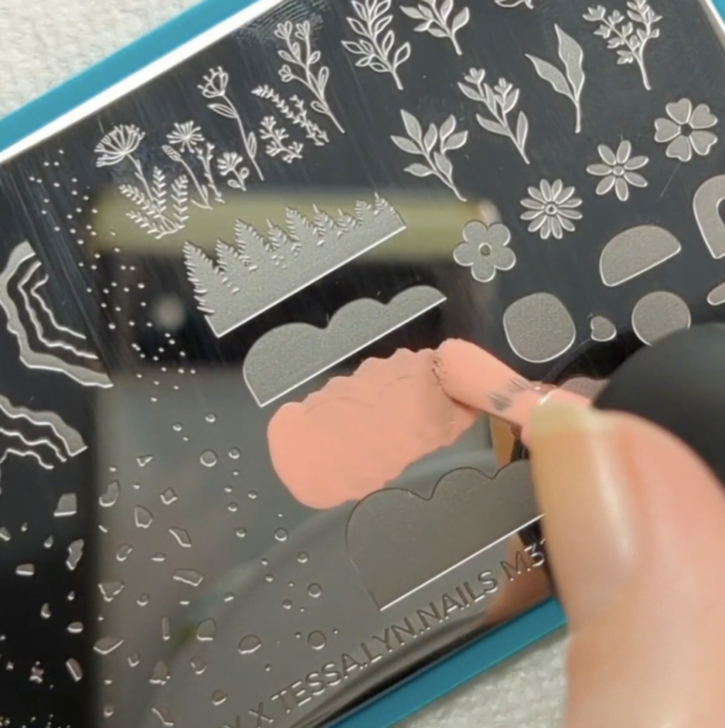 Applying nail polish onto a nail stamping stencil