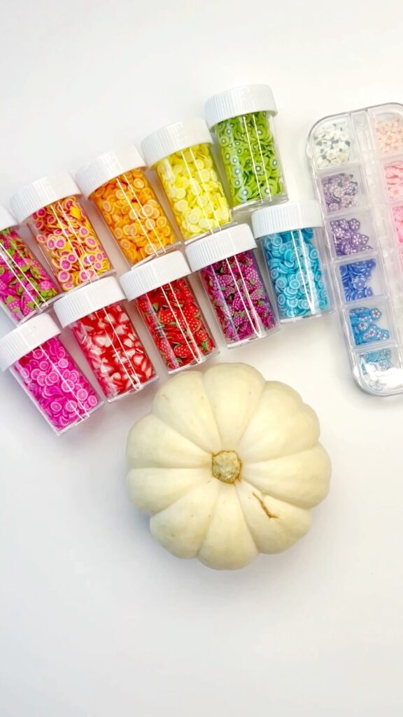 White mini pumpkin with nail art supplies