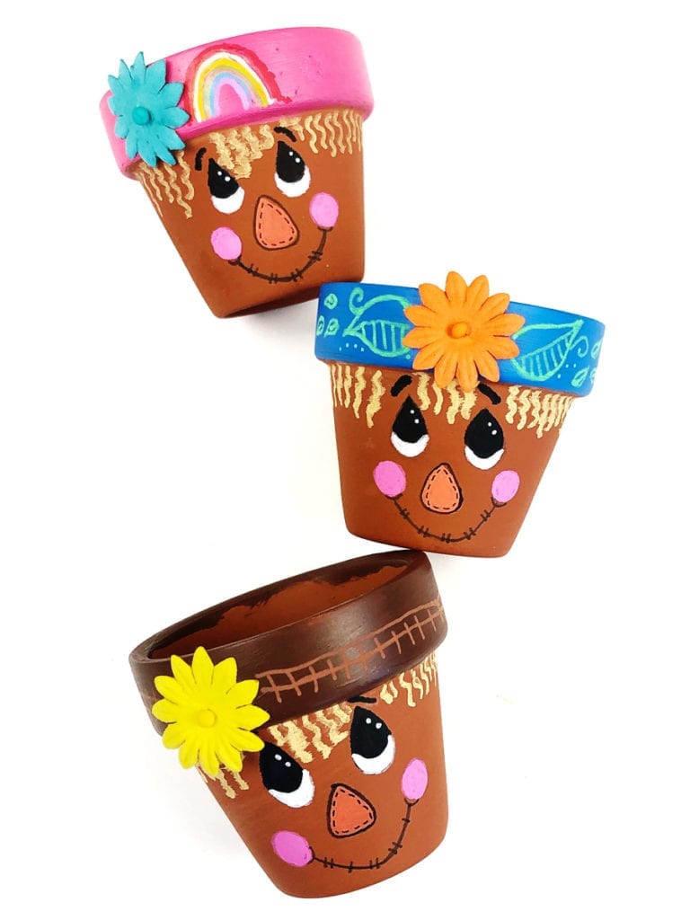 Completed scarecrow flower pot examples